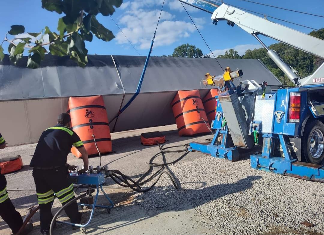 lifting up semi truck that is flipped over
