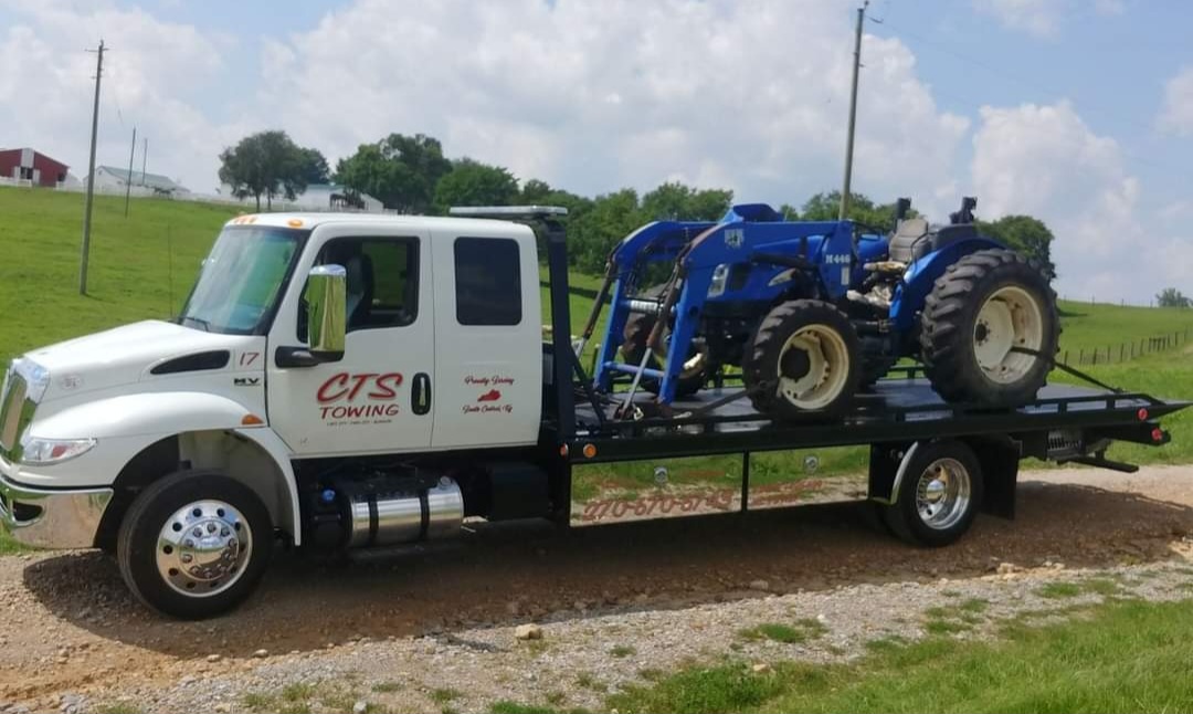 tow truck hauling tractor