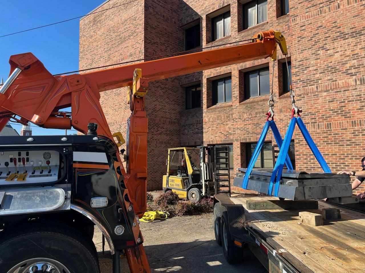 crane tow truck lifting heavy machinery