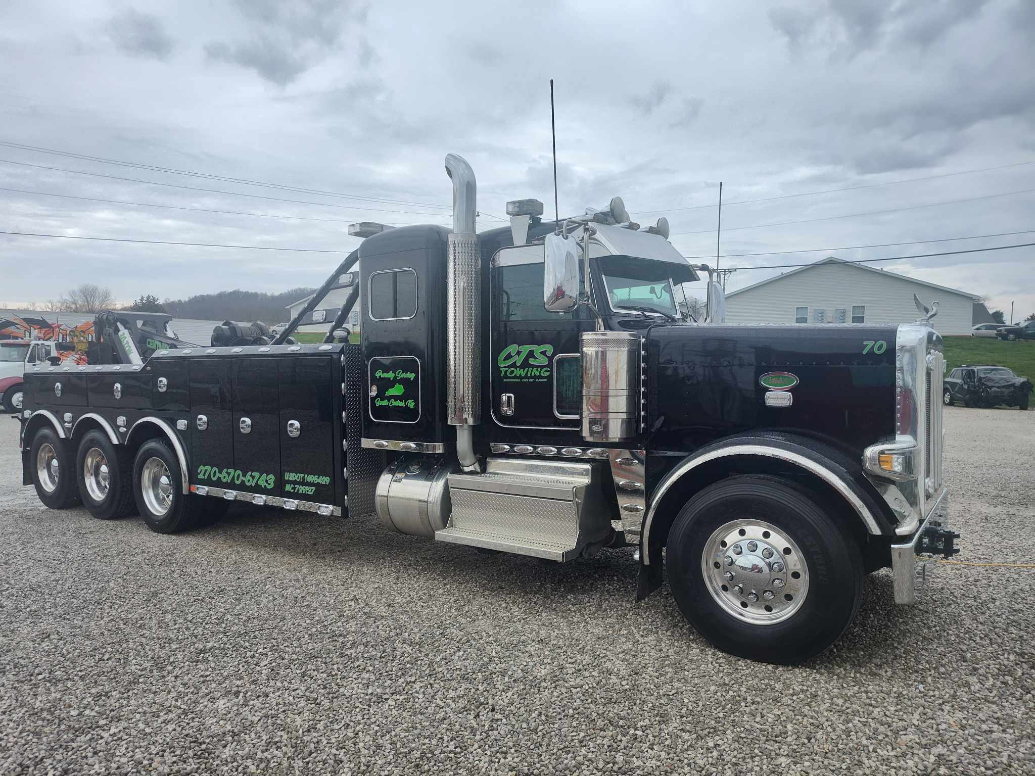 black and green tow truck