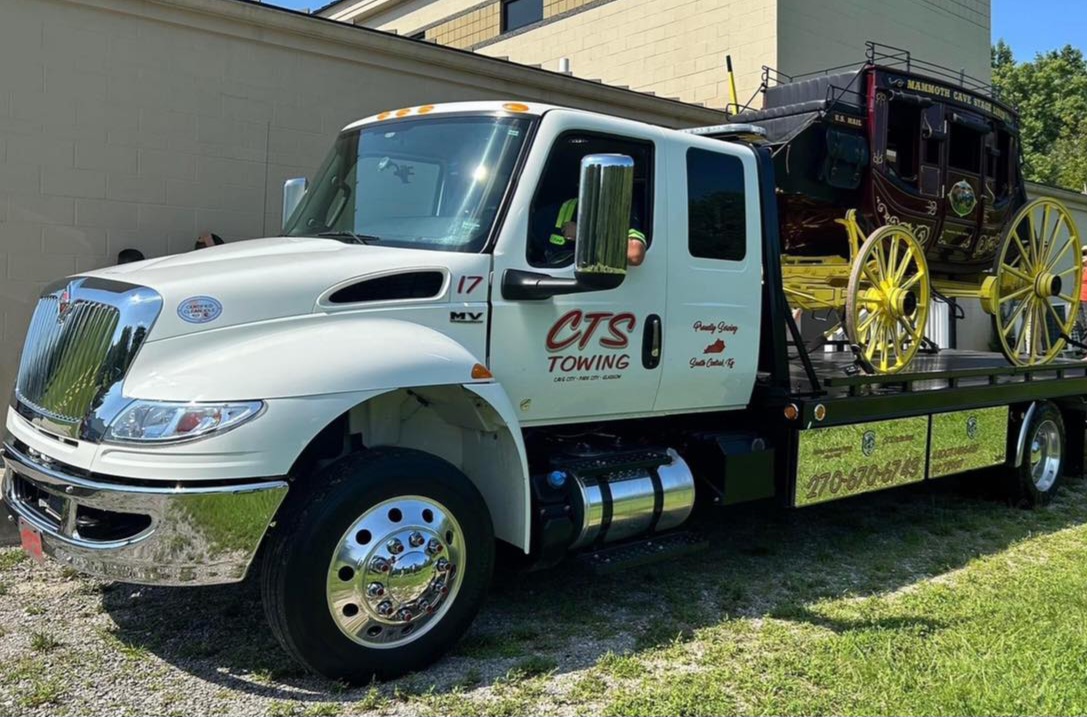 tow truck hauling antique vehicle